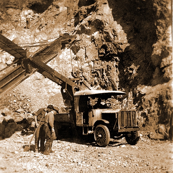 Workers and machinery during excavation for the construction of the Deception Pass Bridge.