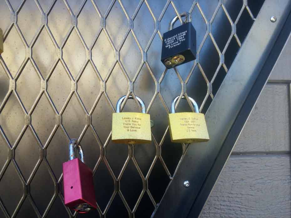 Locks engraved with loved-ones names locked to the iron mesh inside the shape of a heart.