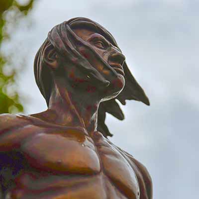 The sculpture of a Native American man focusing on his face