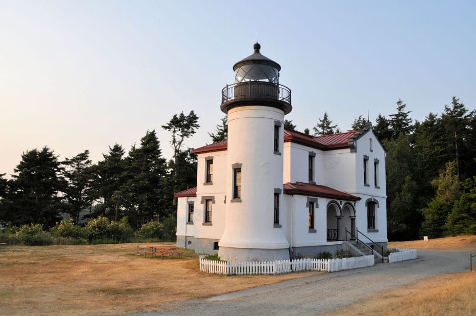 Lighthouse from the outside.  It is Spanish Mission style with a red tile roof.  The light tower is not much taller than the house.