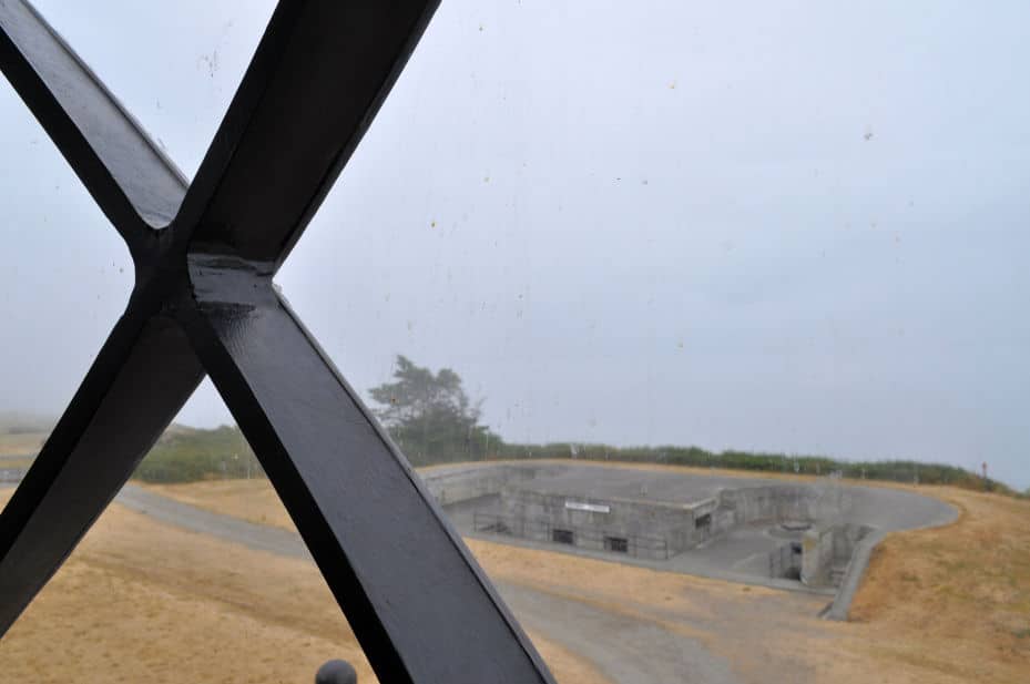 A view out the lighthouse tower shows Fort Casey and the water.