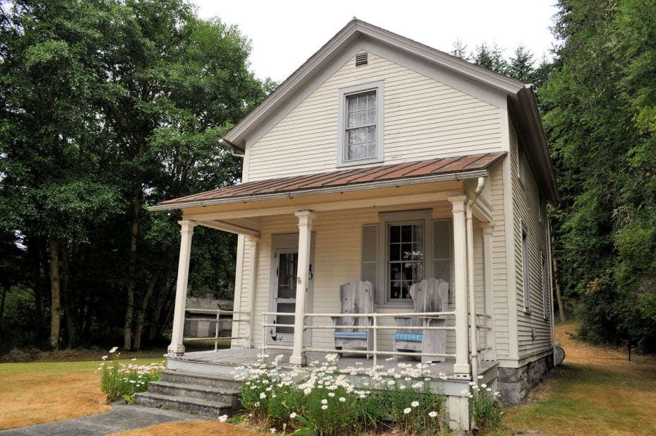 Old wooden house with a big front porch.