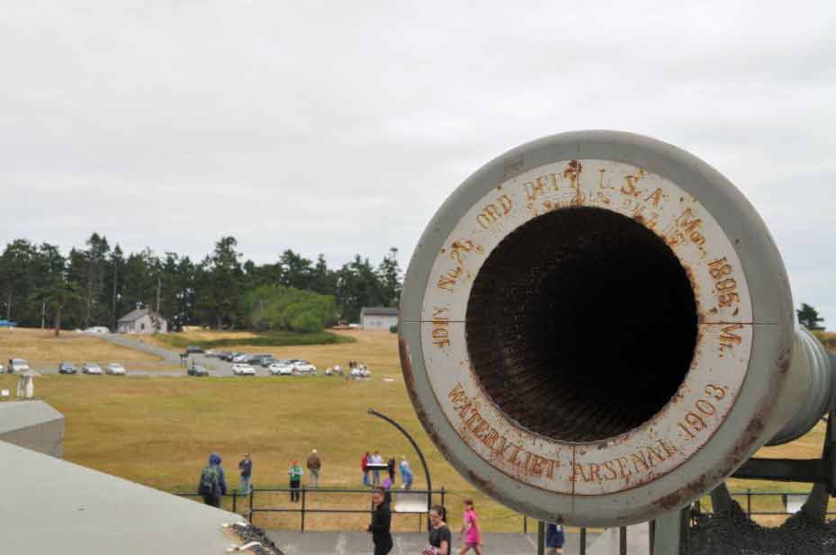 The barrel of one of the big guns with the rest of the fort in the background.