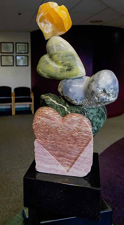Large colorful heart-shaped stones stacked on each other