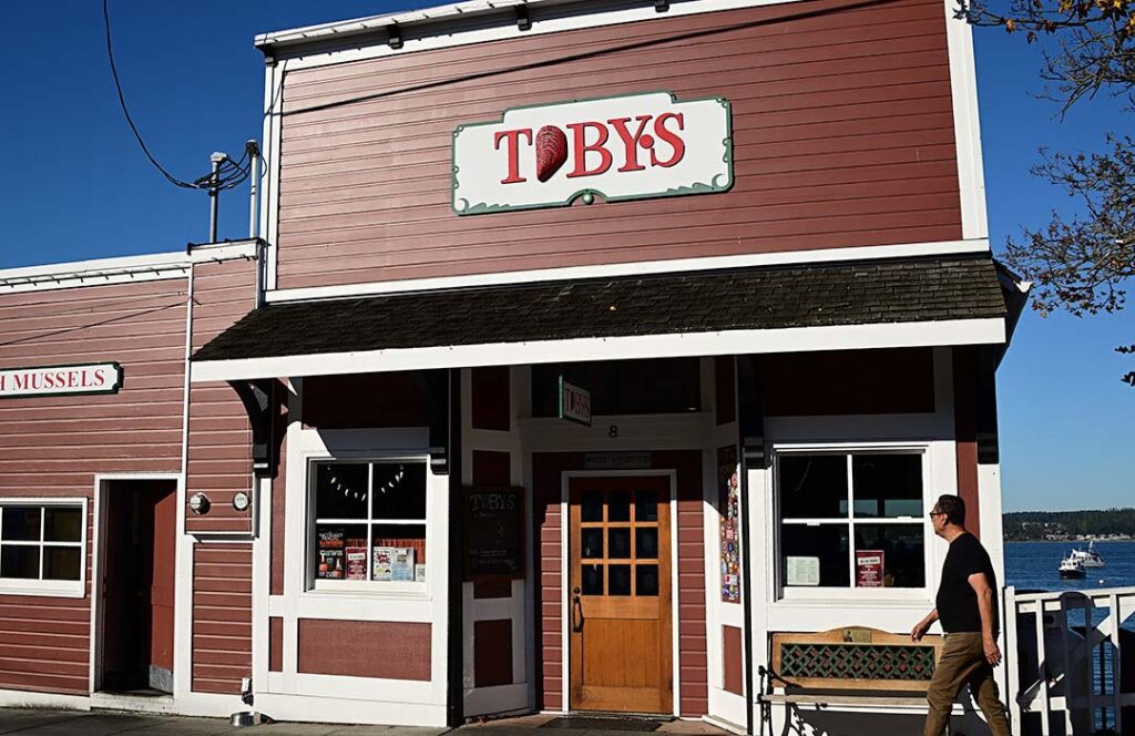Red wooden building with the name Toby's on the front.