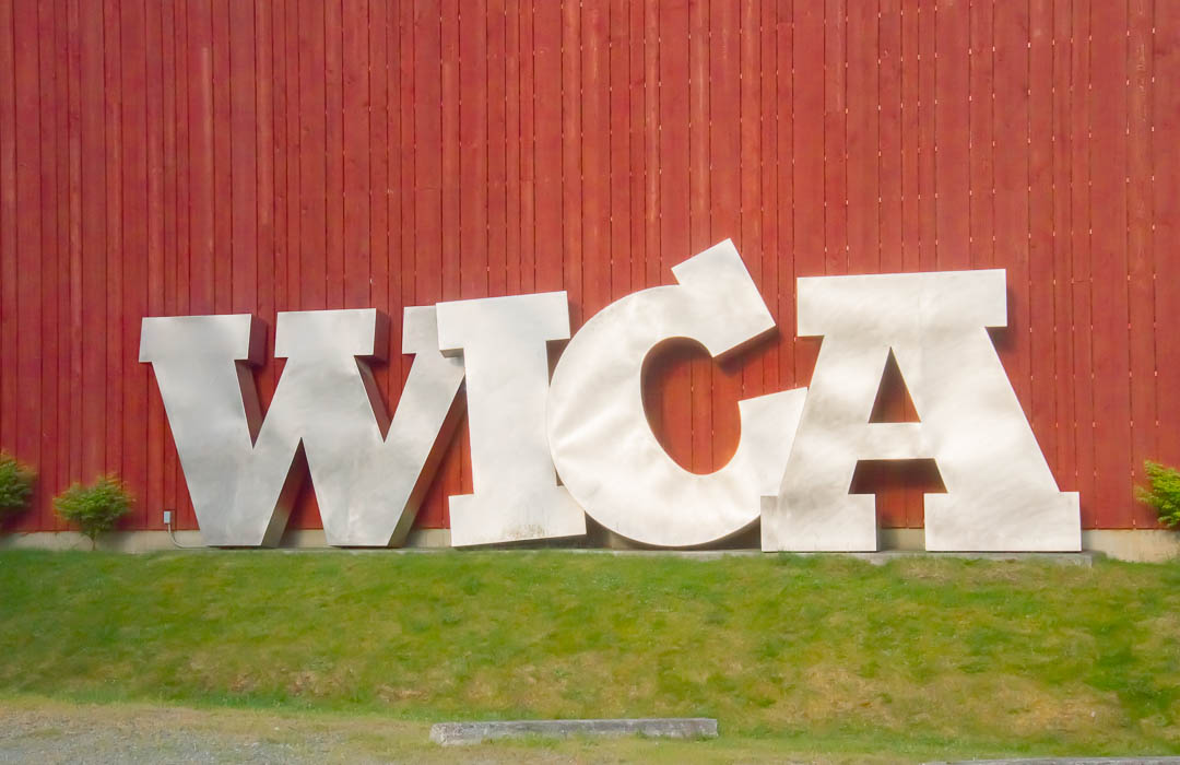 Large metal letters W-I-C_A leaning against a wall.