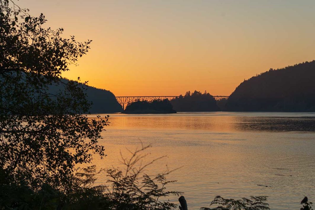 Sun setting at Deception Pass with the bridge in the distance.
