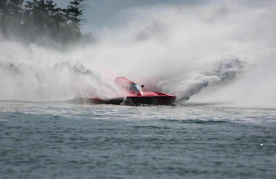 Jet boat with water splashing all around it