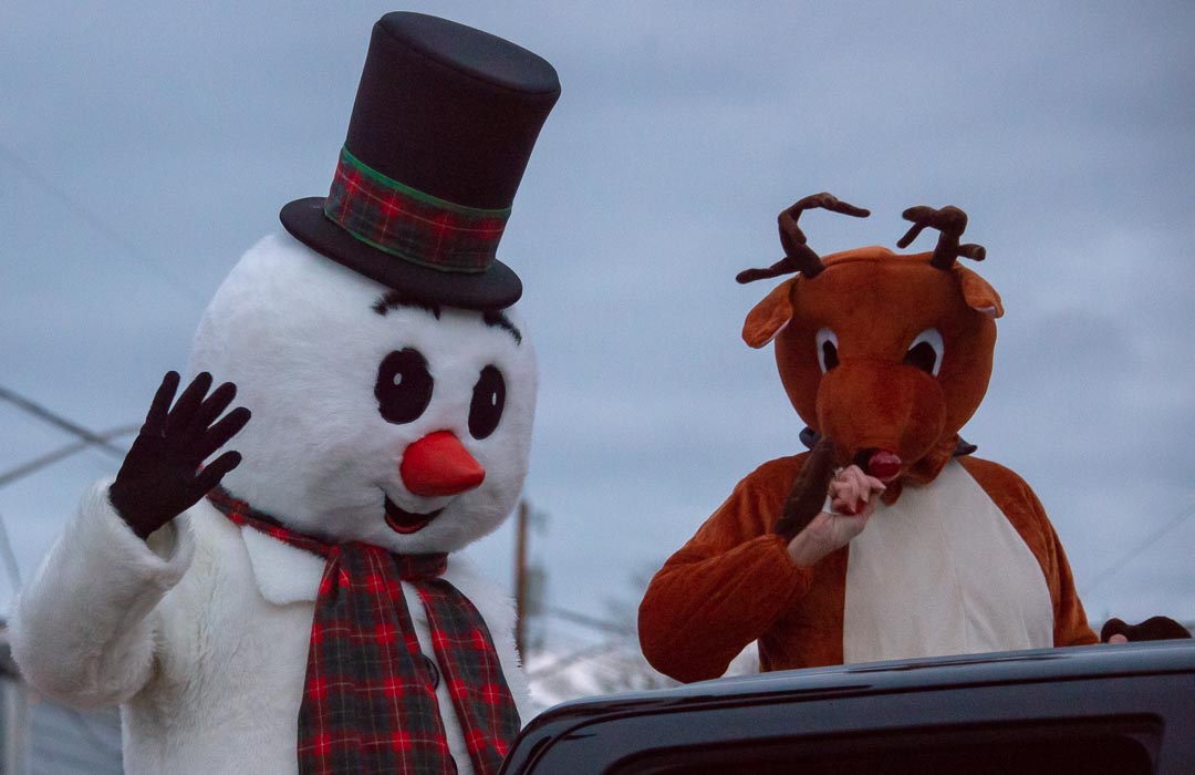 Frosty the Snowman and Rudolph the red-nesed reindeer ride the the Coupeville Christmas Parade