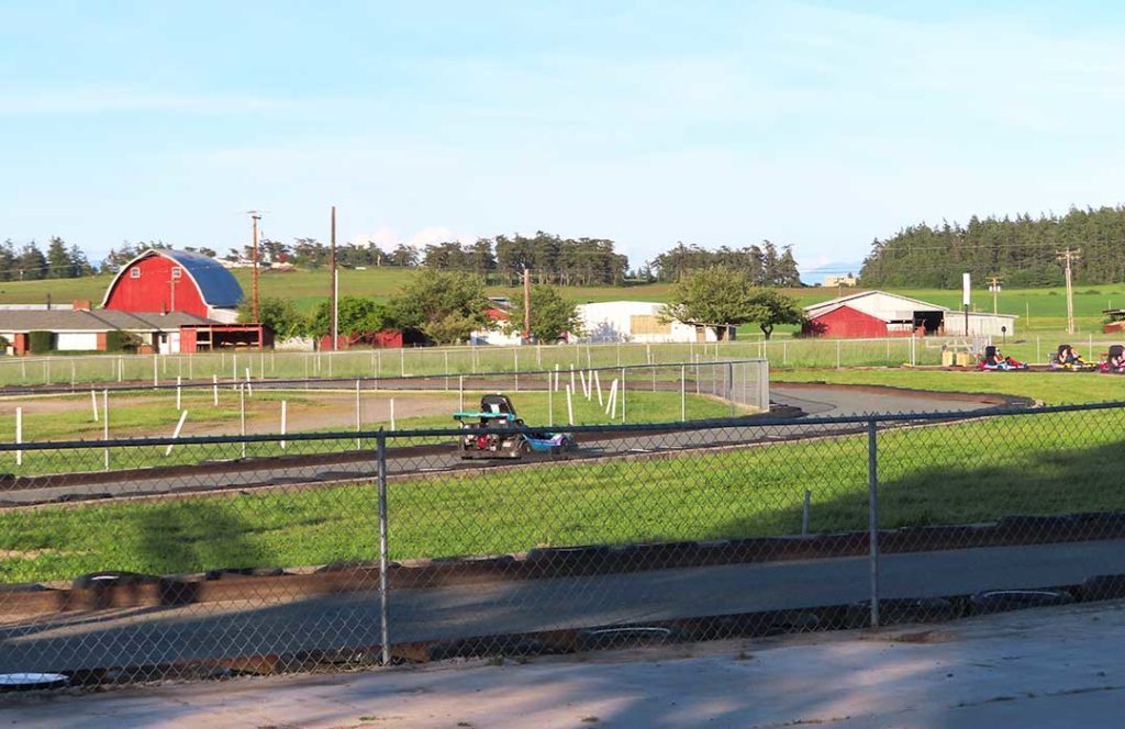 A go-cart races around a track.