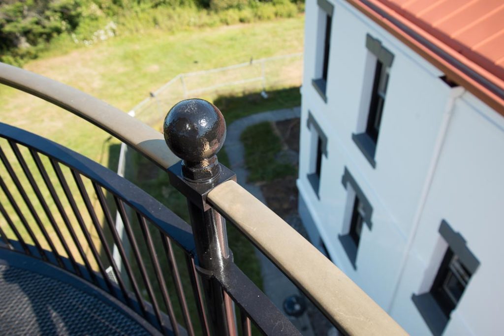 The gleaming railing around the tower at the lighthouse.