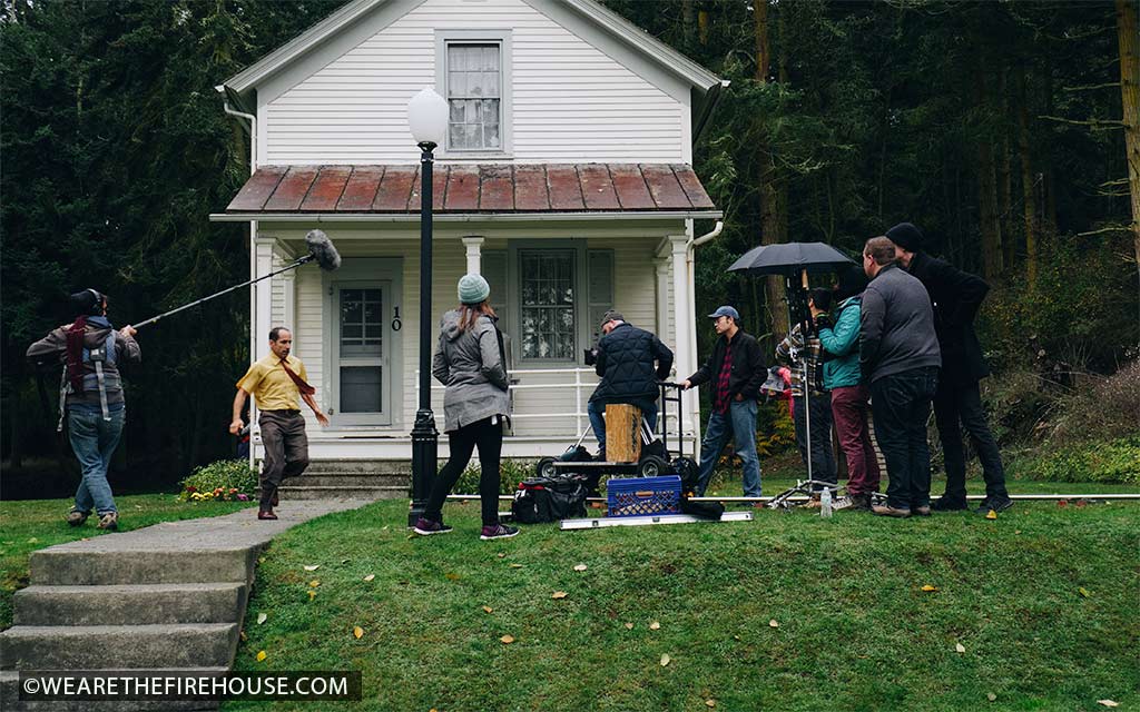 Movie set of an actor running as the crew records him running.