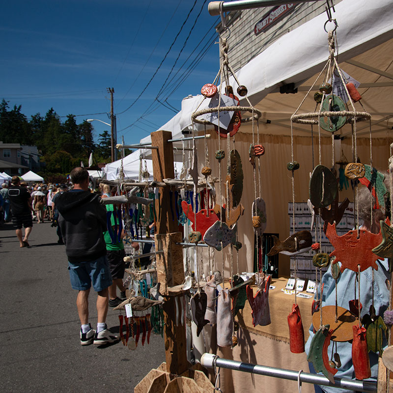 People shop at an open-air art festival.