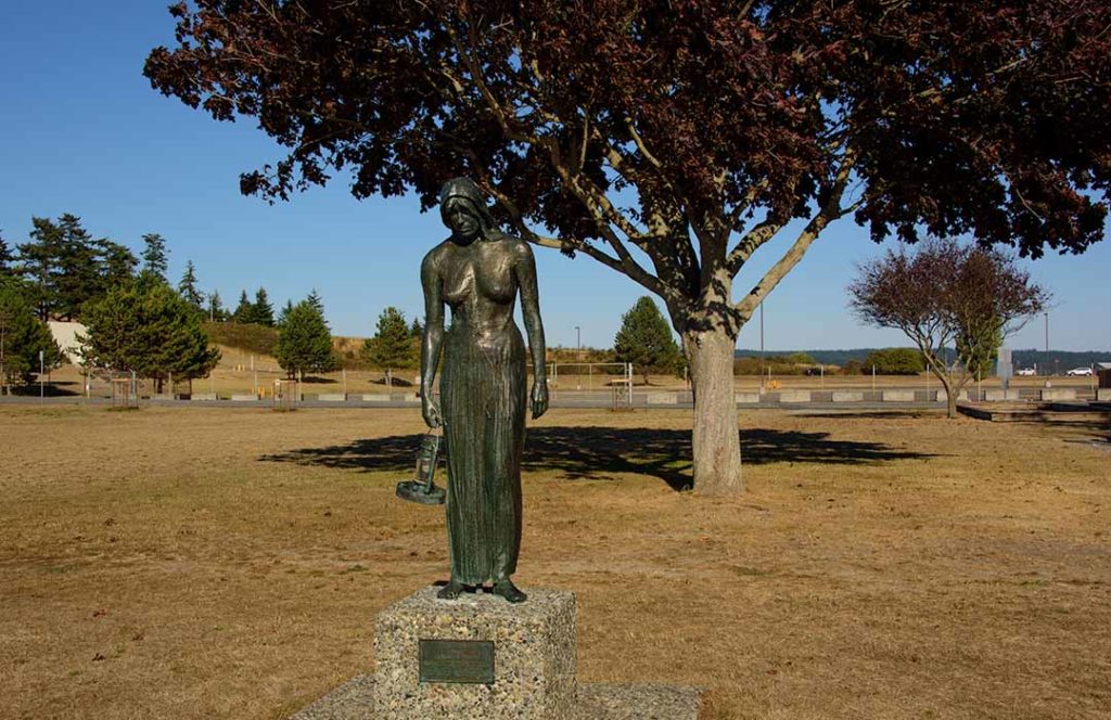 Statue of a woman waiting by the seashore.