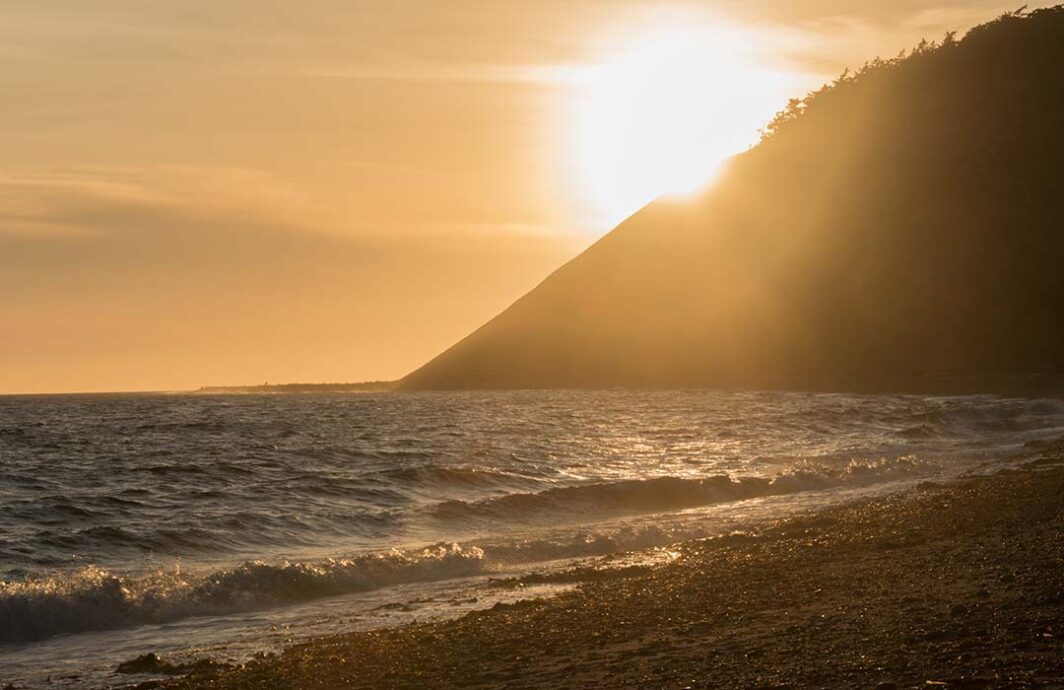 Sun setting behind a bluff at Ebey's Landing