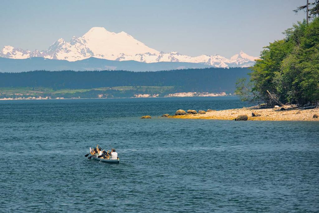 Tribal canoe in Penn Cove and Mount Baker in the background.