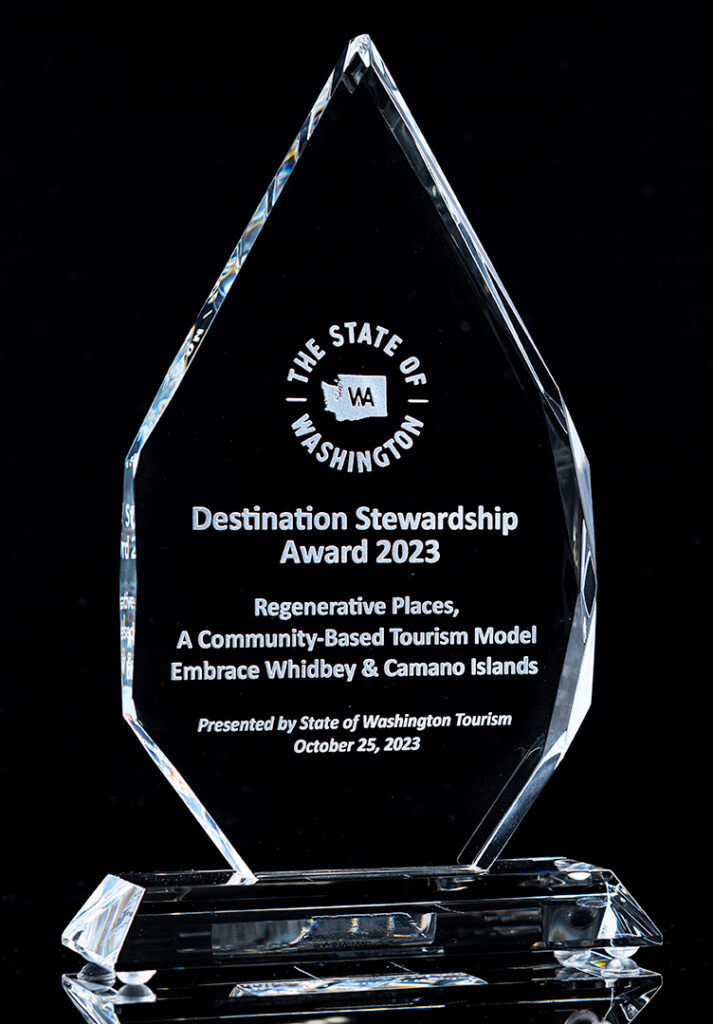 A piece of crystal roughly in the shape of a diamond.  On it is engraved Destination Stewardship Award 2023 and The State of Washington.