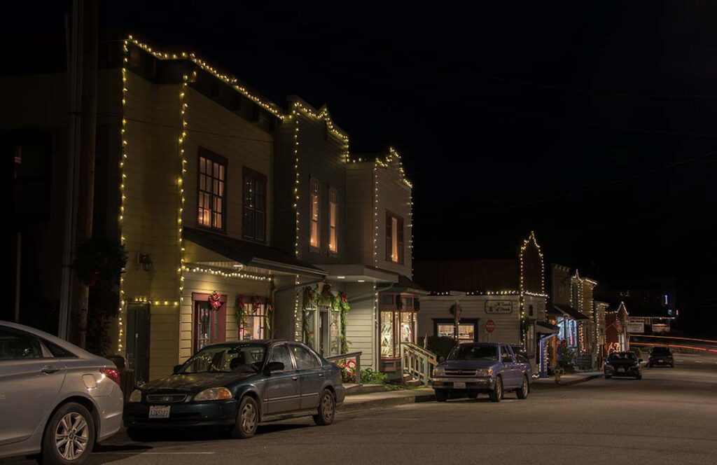 The storefronts of Coupeville with holiday lights.