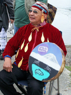 Seated man with a drum.