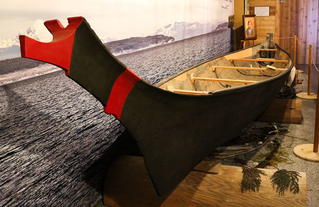 Native American dugout canoe with an elegant black and red bow.