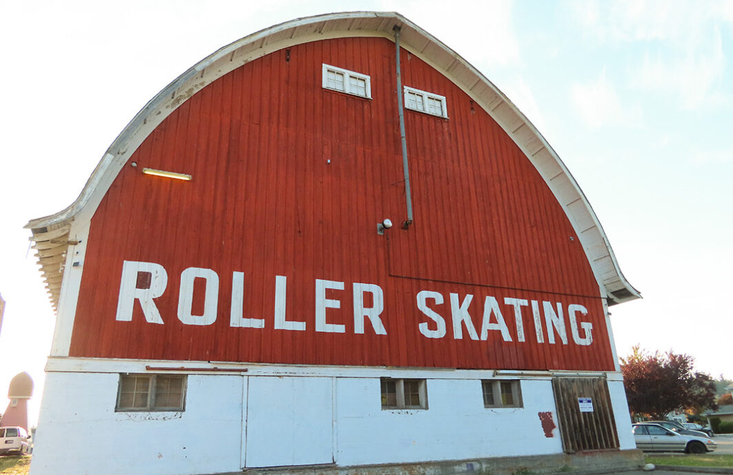 Very large barn with the words roller skating on it.