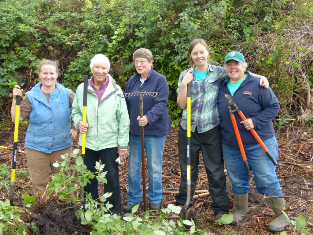 Image of volunteers with yard tools.