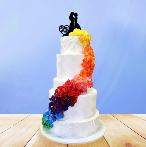 The Cake Theatre Series @ WICA. Image of a wedding cake with rainbow of flowers spiraling up the side of the cake