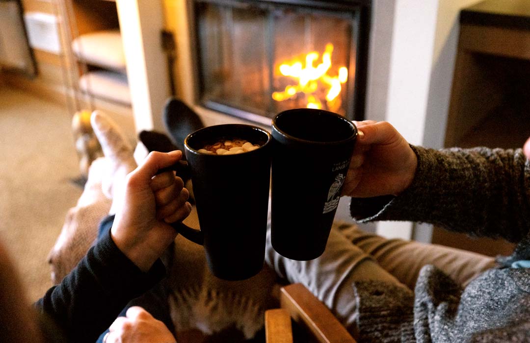 A couple in a cozy room with fireplace