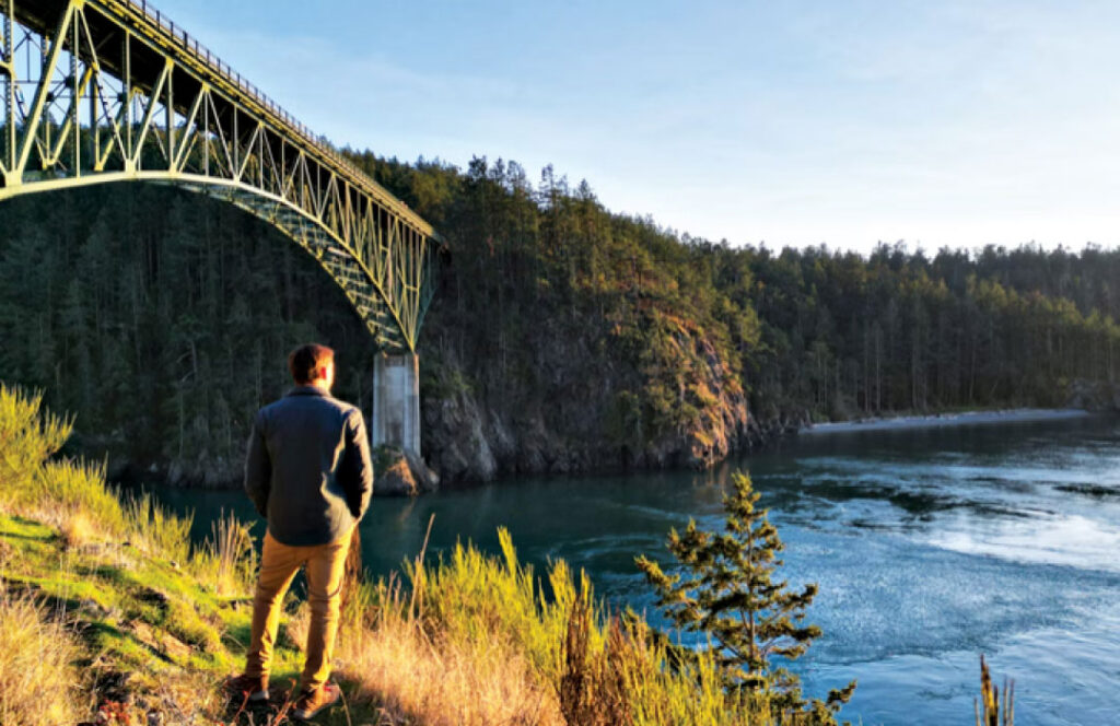 Person look out over Deception Pass Bridge