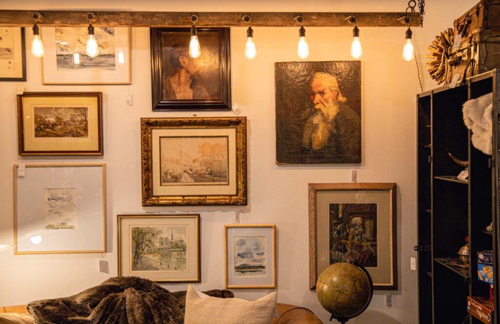 A wall of framed art in Whidbey Island Thrift Store