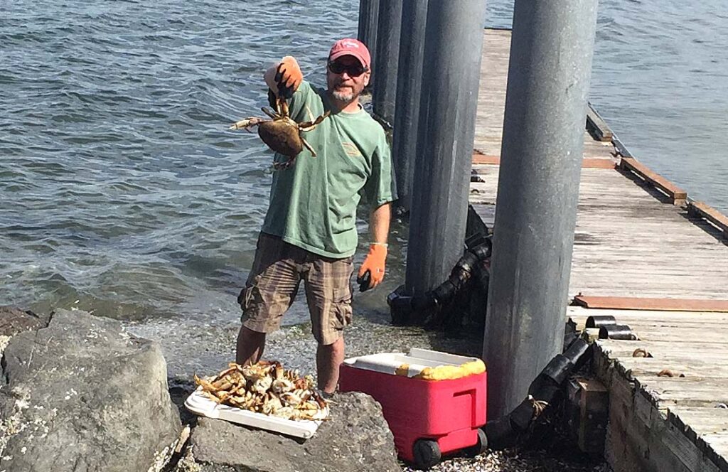Crabber on the beach cleaning his catch