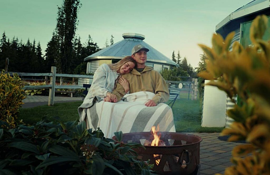 Couple sits at fire pit outside Arrowhead Ranch's Ranchette Silo