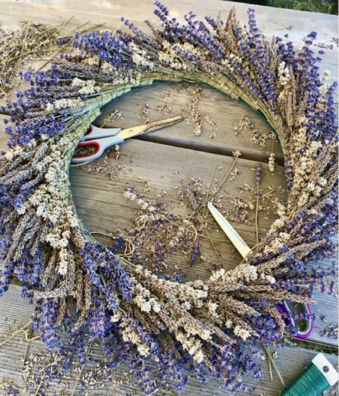 Image of a lavender wreath with scissors and supplies to make the wreath